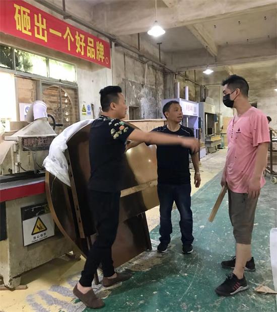 设计师李勤给生产主管详细讲解产品的每一个工艺标准和要求，海德利总经理谷先生也在认真倾听。